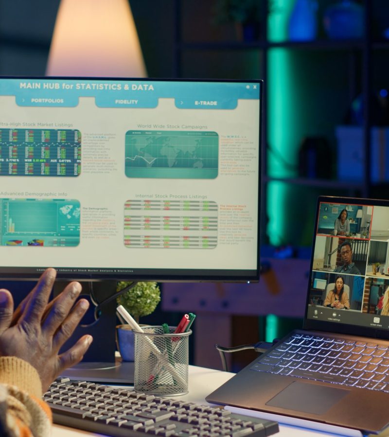 African american male freelancer attends virtual meeting call with clients on laptop, working at home and sharing insight on income statistics. Person listening to video call. Camera A.